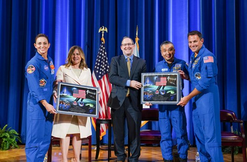 OPM Deputy Director Shriver and an official from the Department of Interior present framed ceremonial pictures to three NASA astronauts.